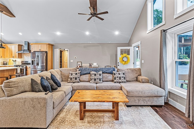 living room featuring ceiling fan, wood-type flooring, and high vaulted ceiling