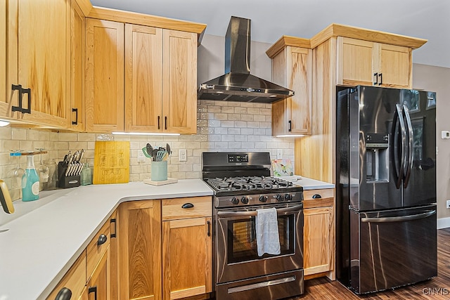 kitchen featuring wall chimney exhaust hood, tasteful backsplash, black fridge with ice dispenser, dark hardwood / wood-style floors, and stainless steel gas range