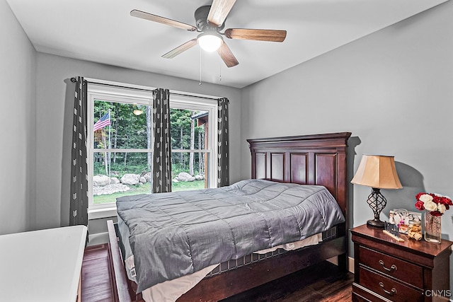 bedroom featuring dark wood-type flooring, multiple windows, and ceiling fan