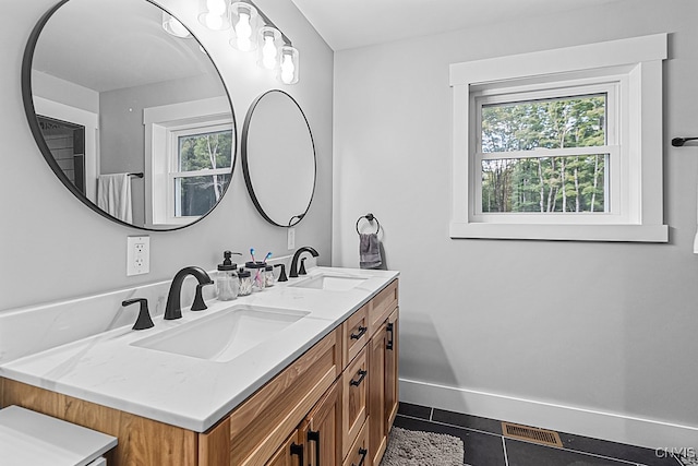 bathroom featuring tile patterned flooring and vanity