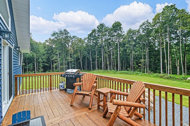 wooden deck with a grill and a yard