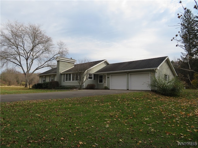 ranch-style home with a front lawn and a garage