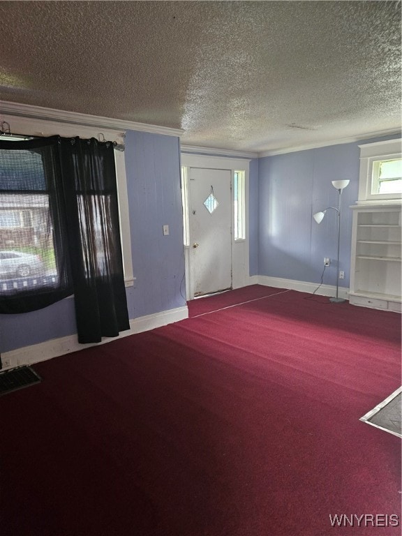 carpeted entryway with a textured ceiling