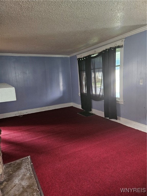 carpeted spare room featuring a textured ceiling and crown molding