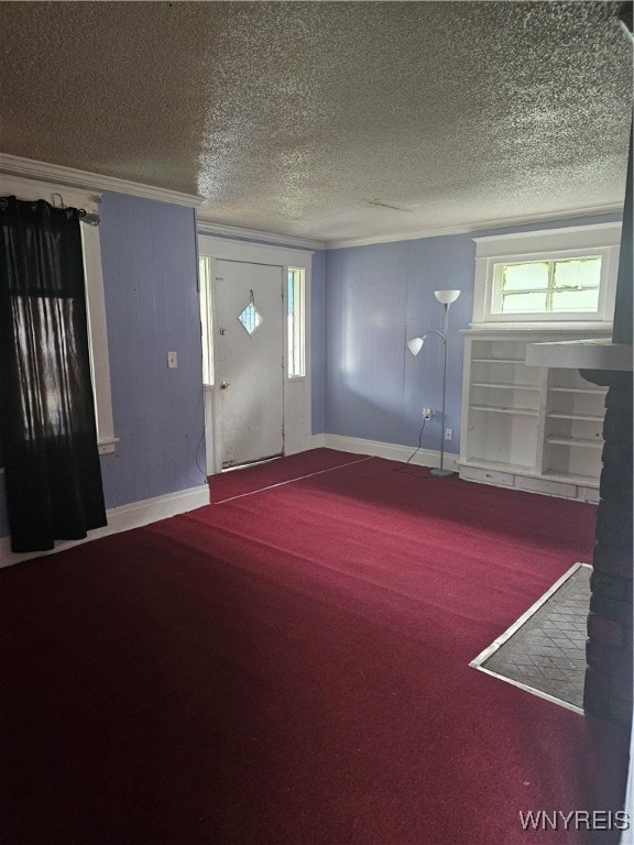 carpeted foyer featuring a textured ceiling