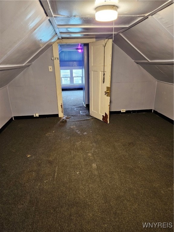 additional living space featuring lofted ceiling