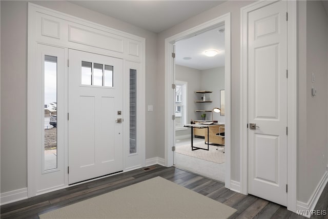 entrance foyer with dark wood-type flooring and plenty of natural light