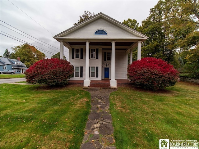 neoclassical / greek revival house featuring a porch and a front lawn