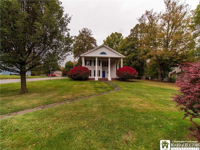 greek revival house featuring a front yard and covered porch