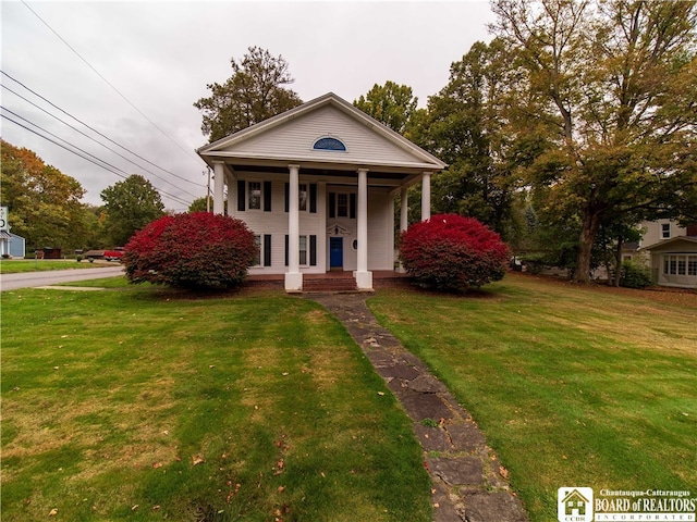 greek revival house featuring a porch and a front yard