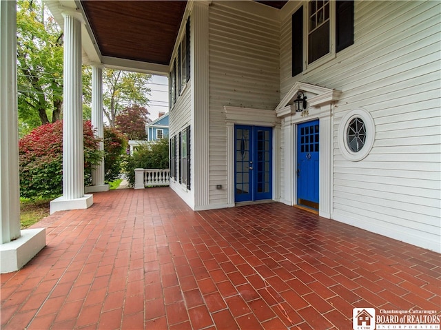 view of patio featuring a porch and french doors