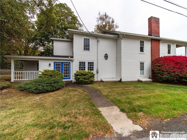 rear view of property with a yard