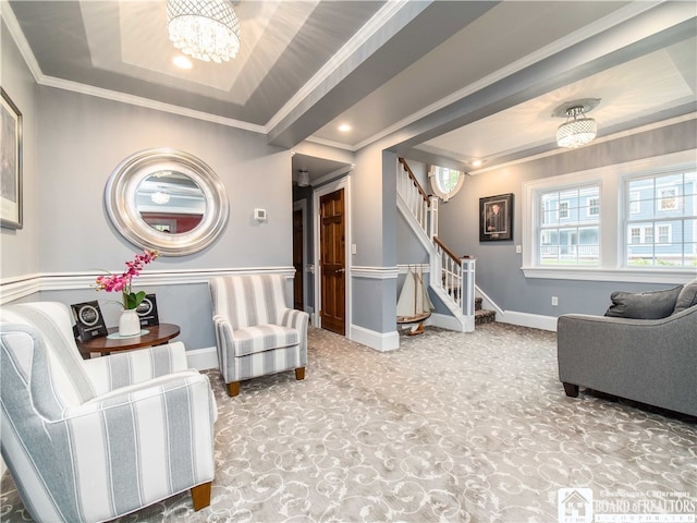 sitting room with a tray ceiling, carpet flooring, crown molding, and a notable chandelier