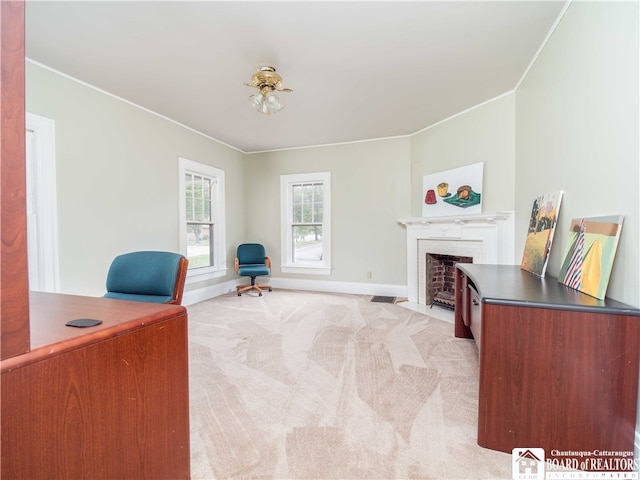 office with light carpet, ornamental molding, and a brick fireplace