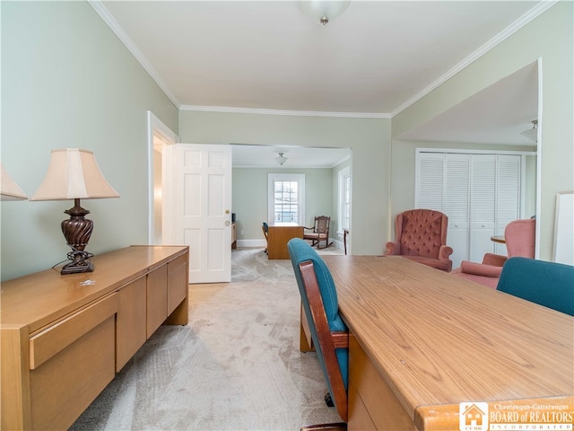 carpeted dining room featuring crown molding