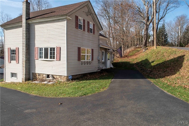 view of side of home featuring a lawn