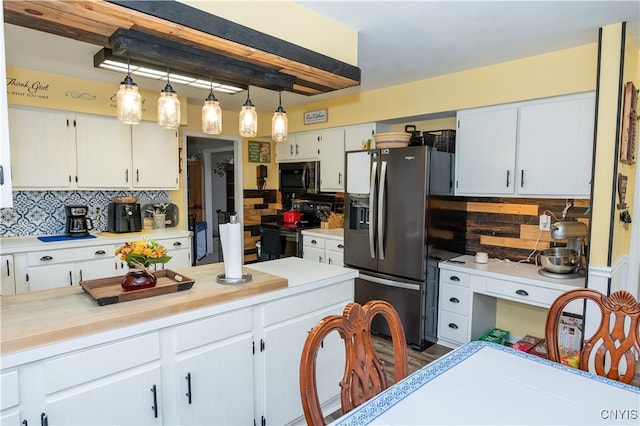 kitchen with white cabinetry, stainless steel appliances, dark hardwood / wood-style floors, pendant lighting, and decorative backsplash