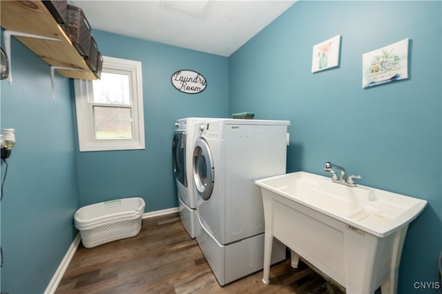 laundry area with washing machine and dryer and dark wood-type flooring