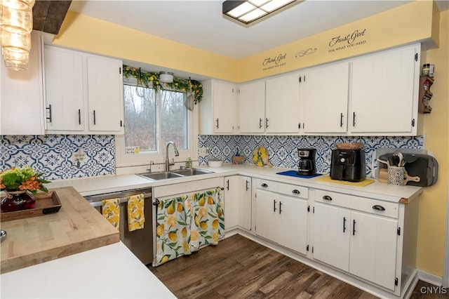 kitchen with white cabinetry, sink, dishwasher, dark wood-type flooring, and tasteful backsplash