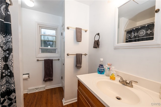 bathroom featuring hardwood / wood-style floors and vanity