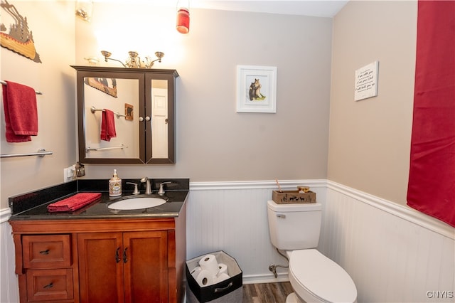 bathroom featuring hardwood / wood-style floors, vanity, and toilet