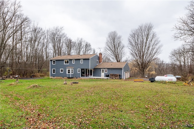 rear view of property featuring a lawn