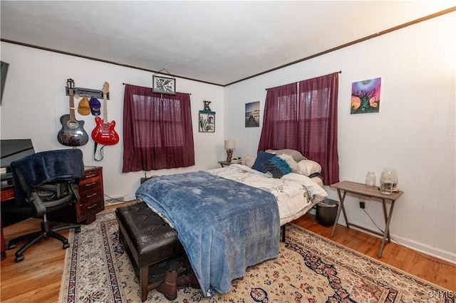 bedroom with hardwood / wood-style flooring and crown molding