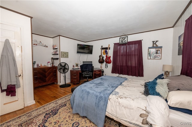 bedroom with wood-type flooring and ornamental molding