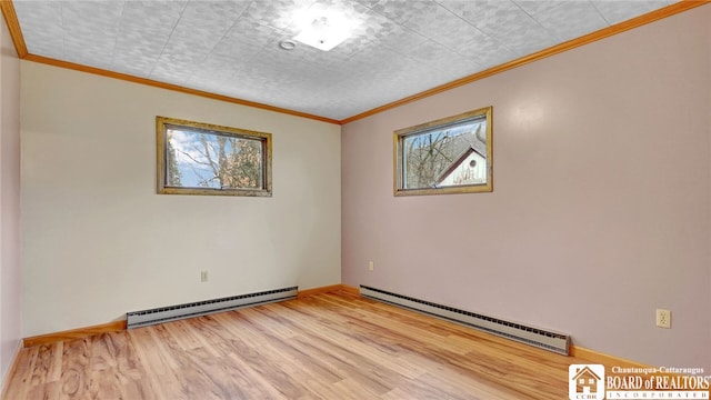 empty room featuring light wood-type flooring, baseboard heating, and crown molding