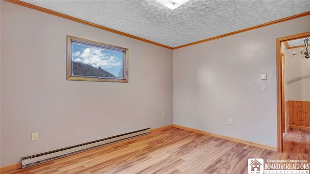 empty room featuring light wood-type flooring, a chandelier, crown molding, and a baseboard radiator