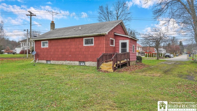 view of side of property with a yard