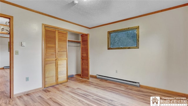 unfurnished bedroom featuring a baseboard radiator, light hardwood / wood-style floors, a textured ceiling, crown molding, and a closet