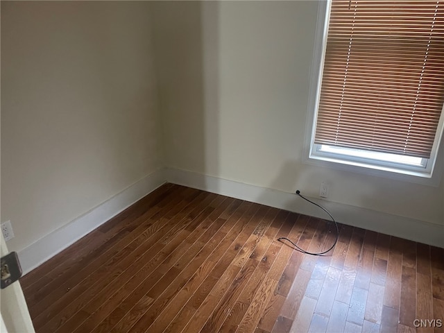 unfurnished room featuring dark wood-type flooring