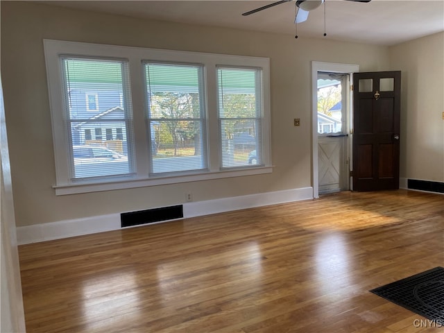 foyer entrance with ceiling fan and wood-type flooring