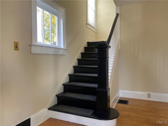 staircase featuring wood-type flooring