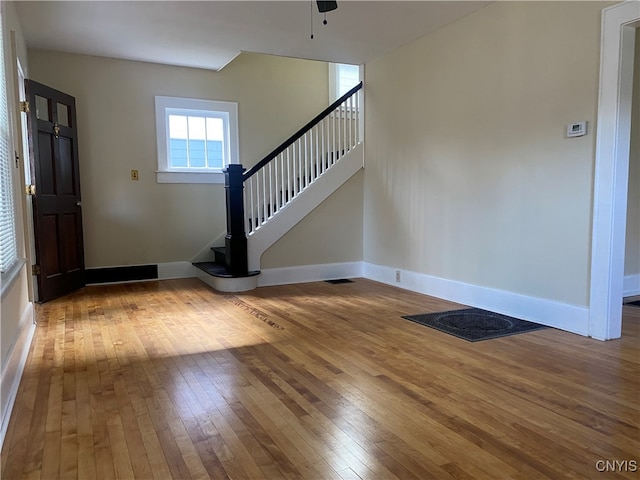 foyer entrance with hardwood / wood-style floors and ceiling fan