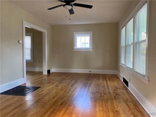 spare room featuring wood-type flooring and ceiling fan