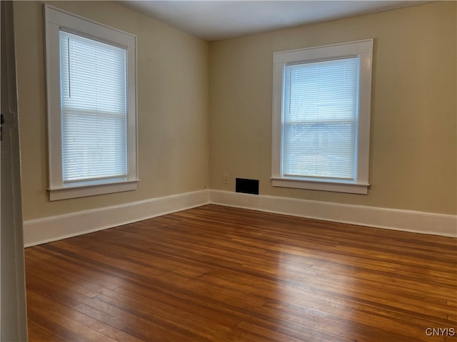 spare room with dark wood-type flooring