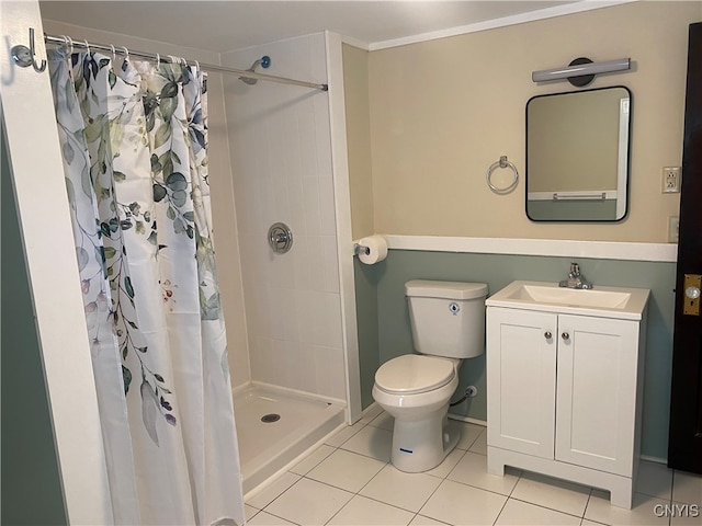 bathroom with toilet, vanity, tile patterned floors, and walk in shower