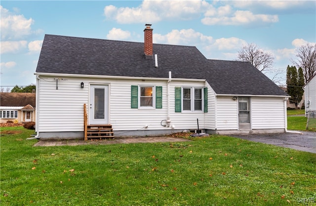 rear view of house with a yard