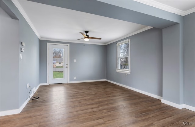 empty room featuring a wealth of natural light, dark hardwood / wood-style floors, and ceiling fan