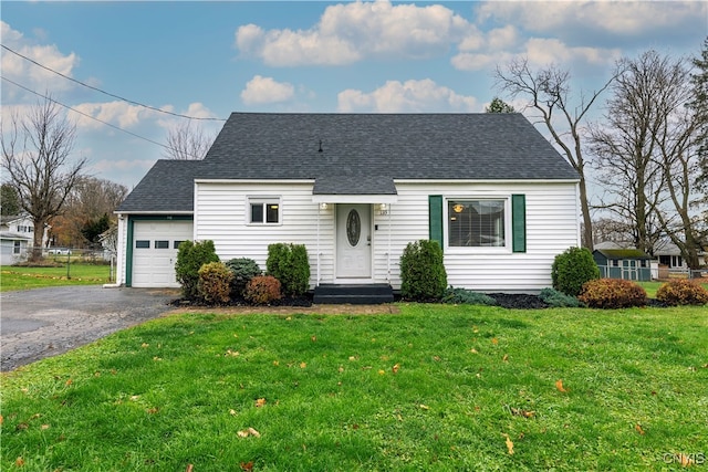 view of front of house with a garage and a front yard