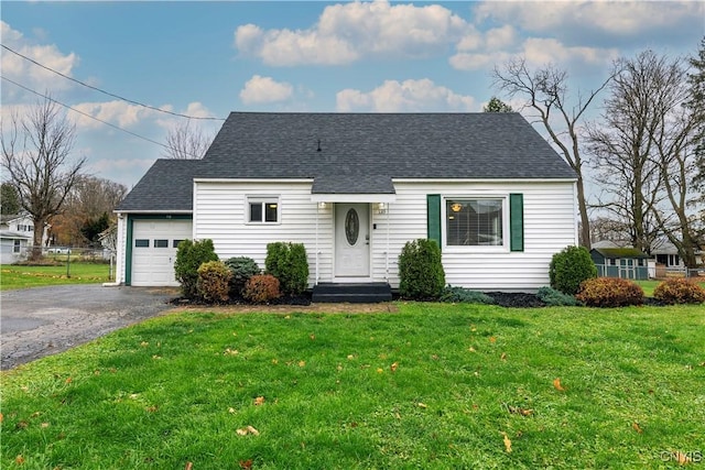 view of front of property featuring a garage and a front lawn