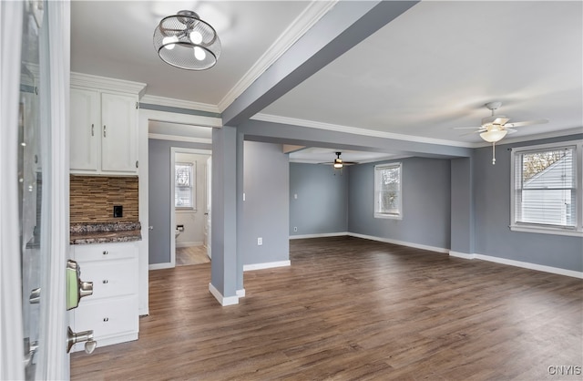 unfurnished living room featuring ornamental molding, dark hardwood / wood-style flooring, and ceiling fan