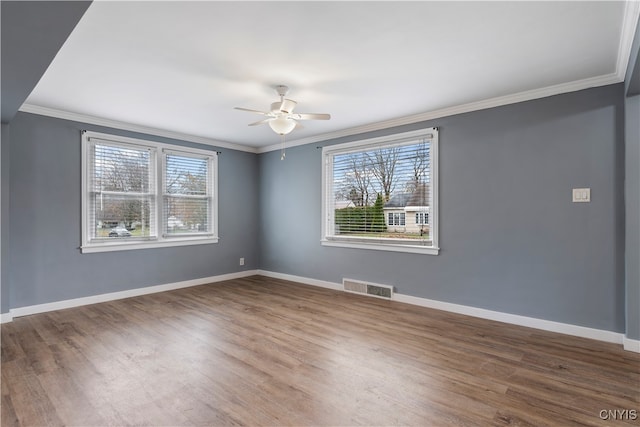 spare room with wood-type flooring, ceiling fan, and crown molding