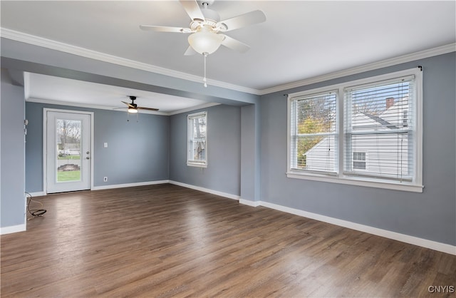 unfurnished room featuring dark wood-type flooring, ceiling fan, and crown molding