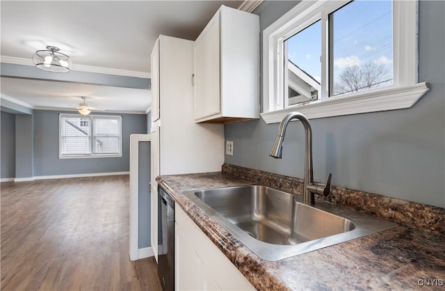 kitchen featuring ornamental molding, black dishwasher, dark hardwood / wood-style flooring, sink, and white cabinets