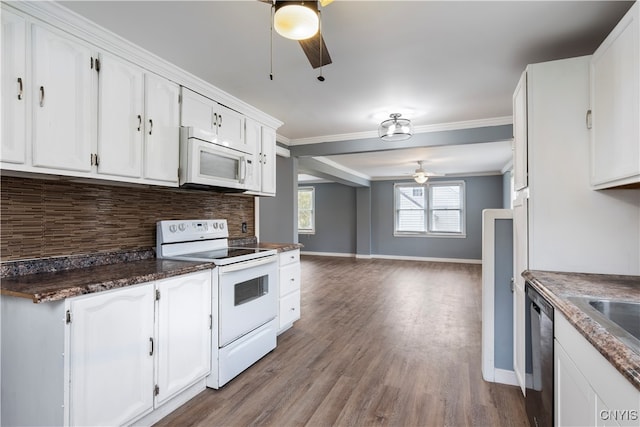 kitchen with white cabinets, hardwood / wood-style flooring, ceiling fan, and white appliances