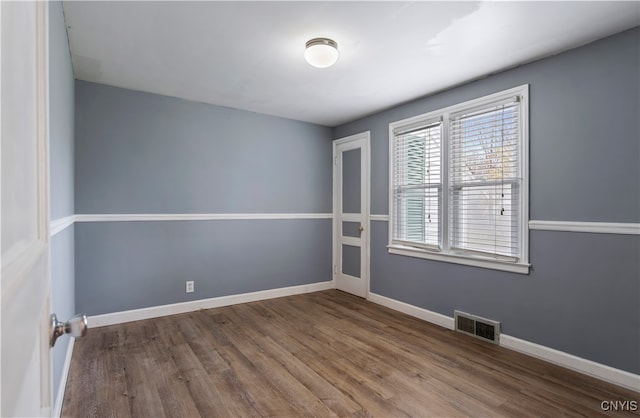 unfurnished room featuring wood-type flooring