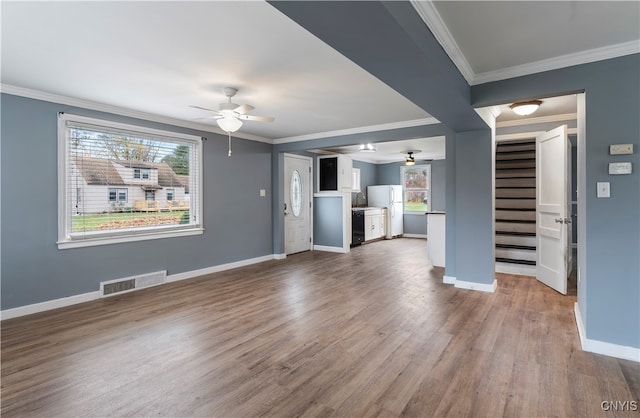 unfurnished living room featuring ornamental molding, wood-type flooring, and ceiling fan